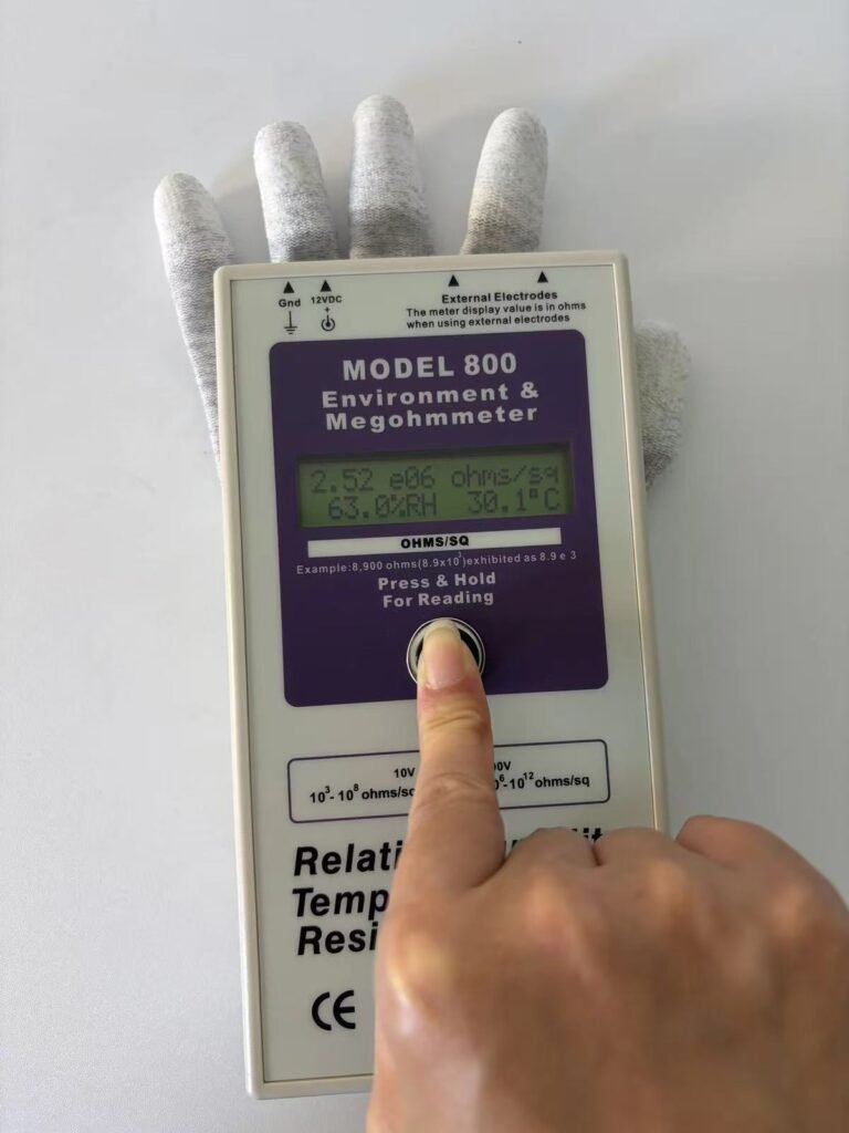 ACL Staticide Model 800 megohmmeter showing 2.52 e06 ohms/sq at 63.0 percent RH and 30.1 degrees C, measuring a carbon fibre ESD glove with PU fingertip coating