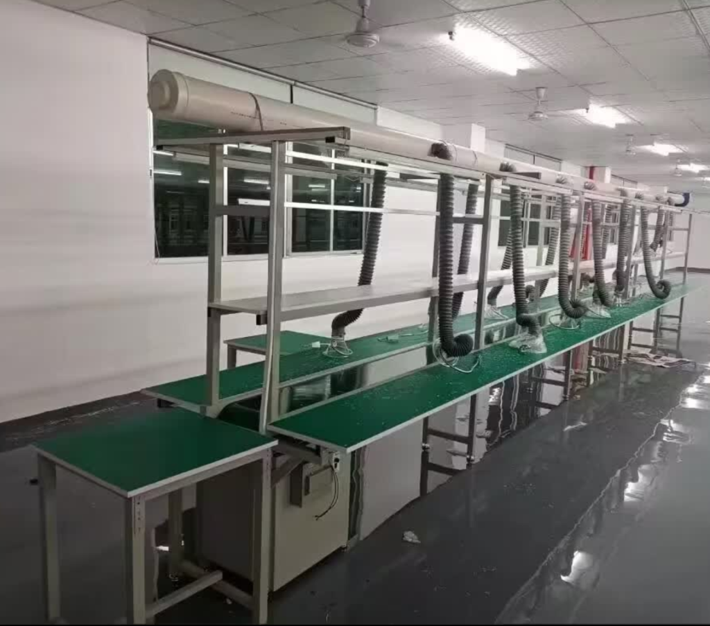 Operator assembling printed circuit boards at a grounded ESD workbench