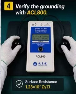 Technician testing an ESD mat surface resistance with an ACL800 megohmmeter and 5 lb electrodes.