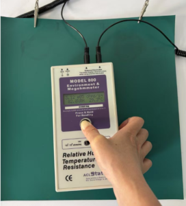 ACL Model 800 megohmmeter reading 3.12 x 10 to the 5 ohms on an ESD bench mat measured using crocodile clip leads at the mat edge