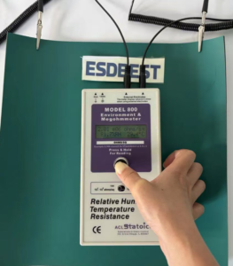 ACL Model 800 megohmmeter reading 2.01 x 10 to the 6 ohms on the green dissipative layer of an ESD bench mat